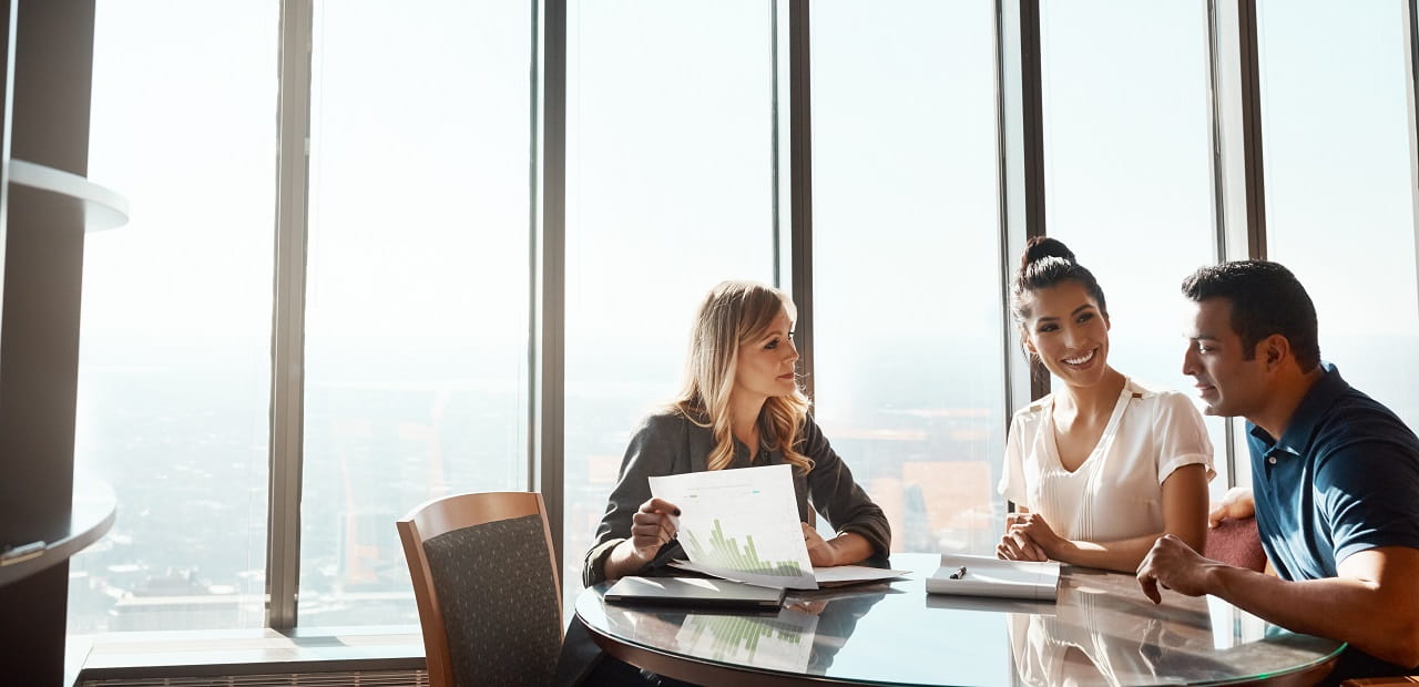 Couple sits at a table with a financial advisor