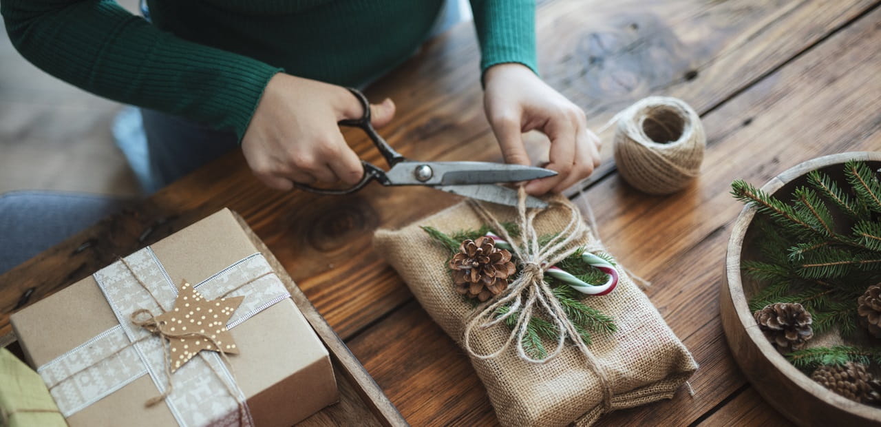 Woman preparing holiday gift with zero waste materials.